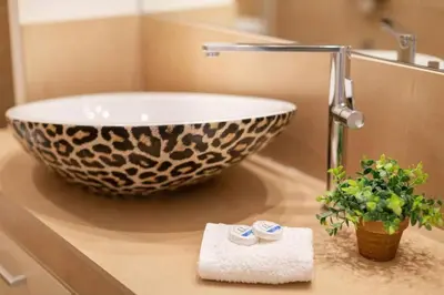 a bathroom with a bowl sink on a counter at Stylish King size bed apt steps from Acropolis by GHH in Athens