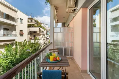 a table on a balcony with a bowl of fruit at Stylish King size bed apt steps from Acropolis by GHH in Athens