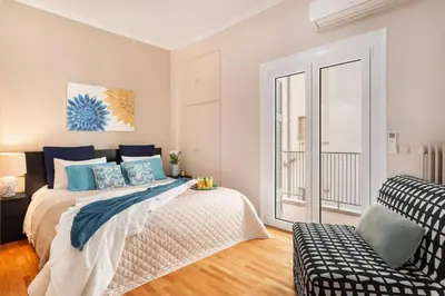 a bedroom with a large bed and a couch at Stylish King size bed apt steps from Acropolis by GHH in Athens
