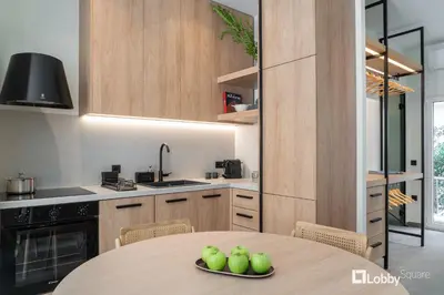 a kitchen with a table with green apples on it at La Mer Apartment by LobbySquare in Piraeus