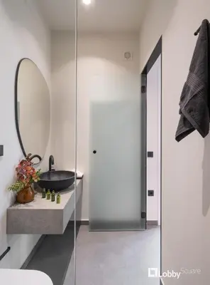 a bathroom with a sink and a mirror at La Mer Apartment by LobbySquare in Piraeus