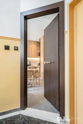 a door leading into a room with a dining room at La Mer Apartment by LobbySquare in Piraeus