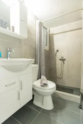 a bathroom with a toilet and a sink and a shower at Comfy Sweet Home in Athens