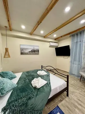 a bedroom with a bed with a green comforter at Cute Corner In The Centre VIPGreece in Athens