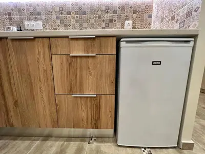a kitchen with a white refrigerator and wooden cabinets at Cute Corner In The Centre VIPGreece in Athens