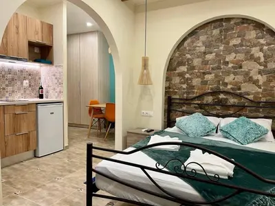 a bedroom with a bed and a stone wall at Cute Corner In The Centre VIPGreece in Athens