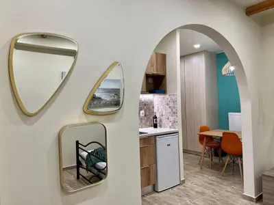 a kitchen with two mirrors on a wall at Cute Corner In The Centre VIPGreece in Athens