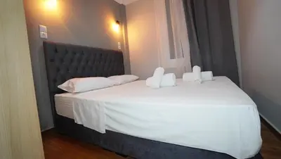 a bedroom with a large white bed with white pillows at Athens City Themis 14 in Athens