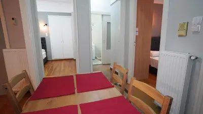 a room with a table and chairs and a bedroom at Athens City Themis 14 in Athens