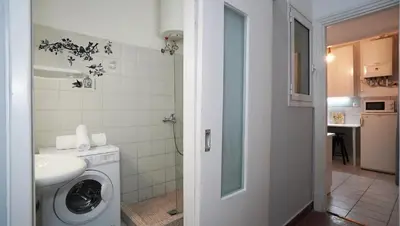 a bathroom with a washing machine and a sink at Athens City Themis 14 in Athens
