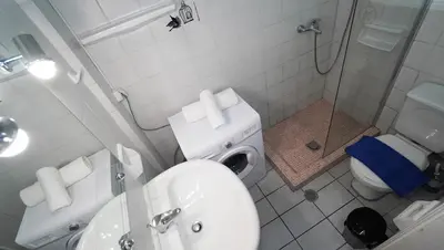 a bathroom with a sink and a toilet and a shower at Athens City Themis 14 in Athens