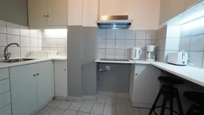 a small kitchen with white cabinets and a sink at Athens City Themis 14 in Athens