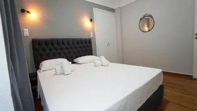 a large white bed in a room with a mirror at Athens City Themis 14 in Athens