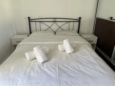 a white bed with two white towels on it at Kali - Thea Spacious 2 BR Penthouse, City View in Athens