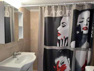 a bathroom with a shower curtain with a woman on it at Kali - Thea Spacious 2 BR Penthouse, City View in Athens