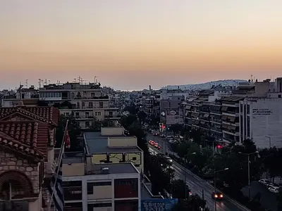 a view of a city skyline at sunset at Kali - Thea Spacious 2 BR Penthouse, City View in Athens