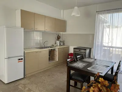 a kitchen with a white refrigerator and a table with chairs at Kali - Thea Spacious 2 BR Penthouse, City View in Athens