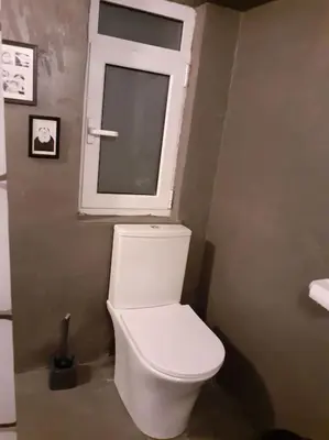 a white toilet in a bathroom with a window at Athens Mets-Central apt in Athens