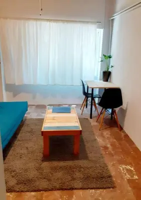 a living room with a coffee table and a table at Athens Mets-Central apt in Athens