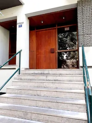 a set of stairs in front of a building with a door at Athens Mets-Central apt in Athens