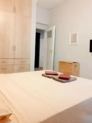 a room with a bed with two towels on it at Athens Mets-Central apt in Athens