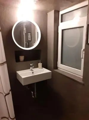 a bathroom with a sink and a mirror at Athens Mets-Central apt in Athens
