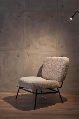 a chair sitting in front of a wall at Cute n Comfort Luxury Condo in Kolonaki in Athens