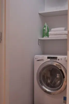 a washer and dryer in a white laundry room at Cute n Comfort Luxury Condo in Kolonaki in Athens