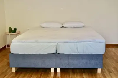a bed with two pillows on top of it at Glyfada Path of Poets in Athens
