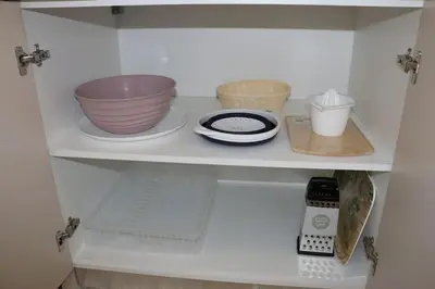 a shelf with bowls and other kitchen items on it at Glyfada Path of Poets in Athens