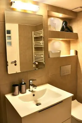 a bathroom with a sink and a mirror at Glyfada Path of Poets in Athens
