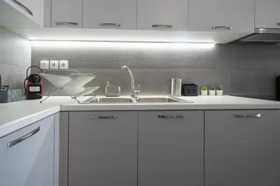a kitchen with white cabinets and a sink at Exclusive apartment in the heart of Athens in Athens