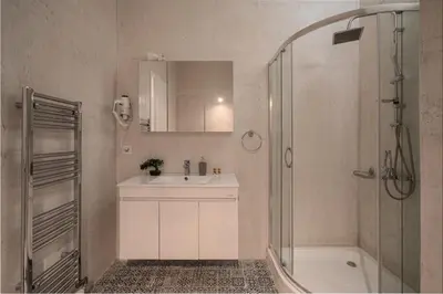a white bathroom with a sink and a shower at Exclusive apartment in the heart of Athens in Athens