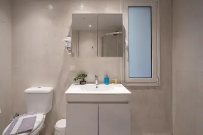 a bathroom with a sink and a toilet and a mirror at Exclusive apartment in the heart of Athens in Athens