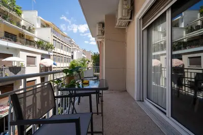 a balcony with a table and chairs on a balcony at Exclusive apartment in the heart of Athens in Athens