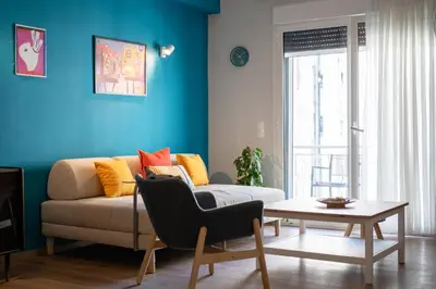 a living room with a couch and a table at Exclusive apartment in the heart of Athens in Athens