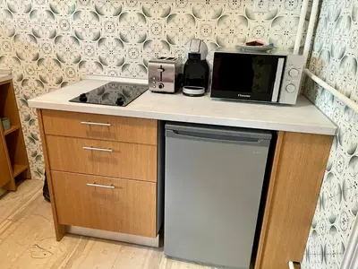 a kitchen with a counter with a microwave and a dishwasher at Cute Nikis Apartment VIPGreece in Athens