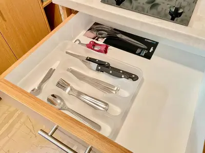 a white tray with utensils in a drawer at Cute Nikis Apartment VIPGreece in Athens