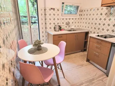 a kitchen with a table and chairs and a sink at Cute Nikis Apartment VIPGreece in Athens