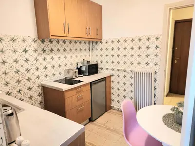 a small kitchen with a counter and a table at Cute Nikis Apartment VIPGreece in Athens