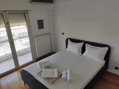 a bedroom with a bed with two towels on it at Luxury Living Athens by YHA in Athens