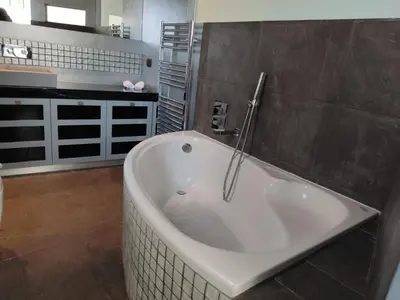 a bathroom with a bath tub in a room at Luxury Living Athens by YHA in Athens