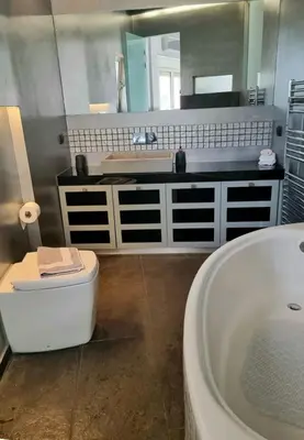 a bathroom with a tub and a toilet and a sink at Luxury Living Athens by YHA in Athens