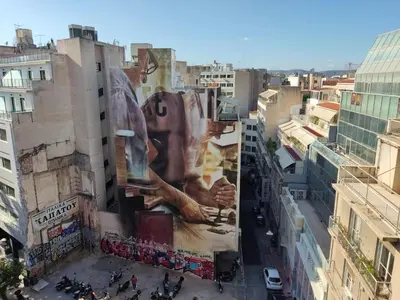 a building with a large mural on the side of it at Luxury Living Athens by YHA in Athens