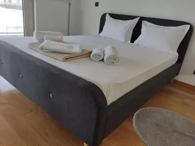 a large bed with towels on top of it at Luxury Living Athens by YHA in Athens