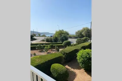 a view of a garden from a balcony at Lagonisi Luxury Apartment by the sea in Lagonissi
