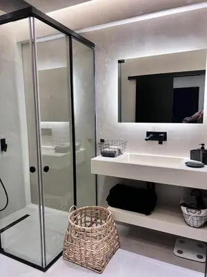 a bathroom with a shower and a sink and a mirror at Lagonisi Luxury Apartment by the sea in Lagonissi