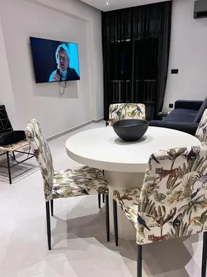 a dining room with a table and two chairs at Lagonisi Luxury Apartment by the sea in Lagonissi