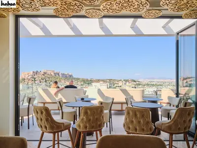 a room with tables and chairs and a large window at NYX Esperia Palace Hotel Athens by Leonardo Hotels in Athens