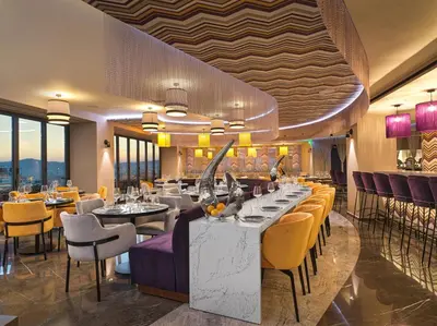 a restaurant with tables and chairs in a room at NYX Esperia Palace Hotel Athens by Leonardo Hotels in Athens